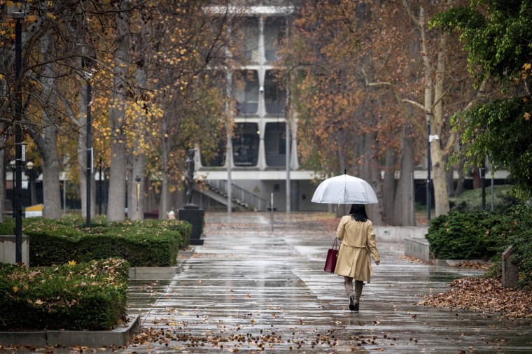 A person walks in the rain in Van Nuys, Calif.