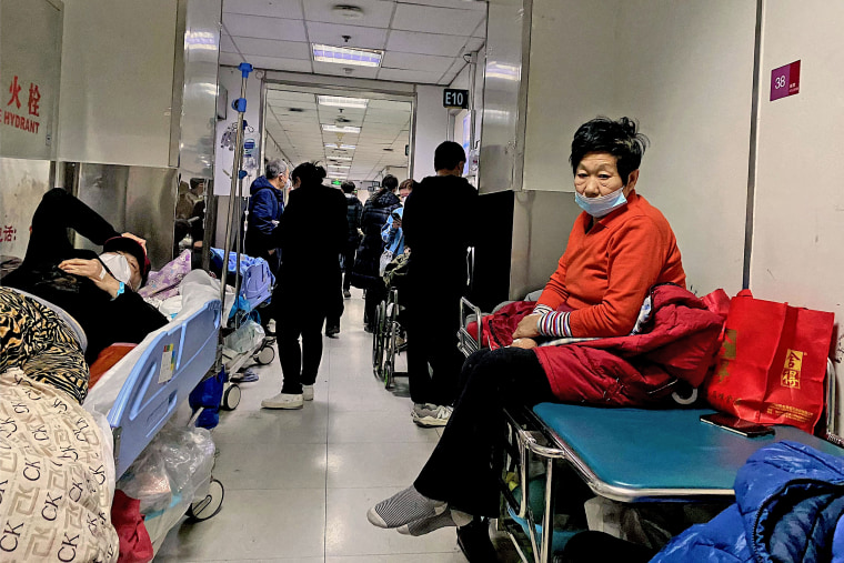 A Covid-19 patient, left, on a gurney at Tianjin First Center Hospital in Tianjin on Dec. 28, 2022.