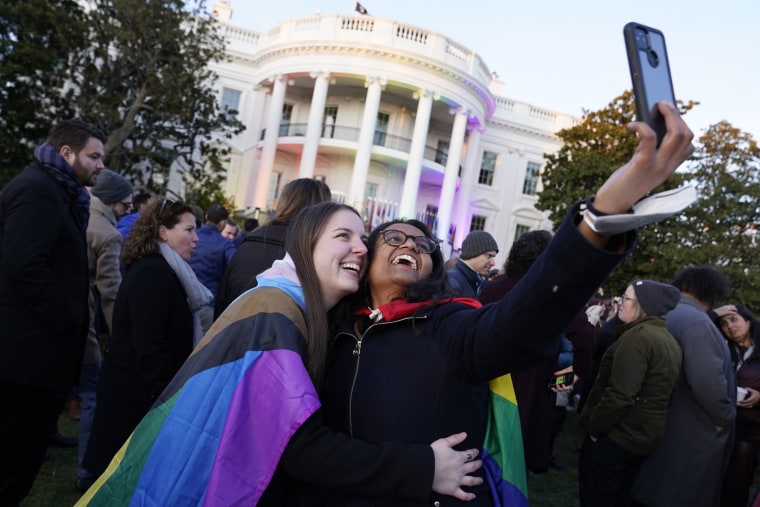 Aparna Shrivastava, right, takes a photo with Shelby Teeter after President Joe Biden signed the Respect for Marriage Ac