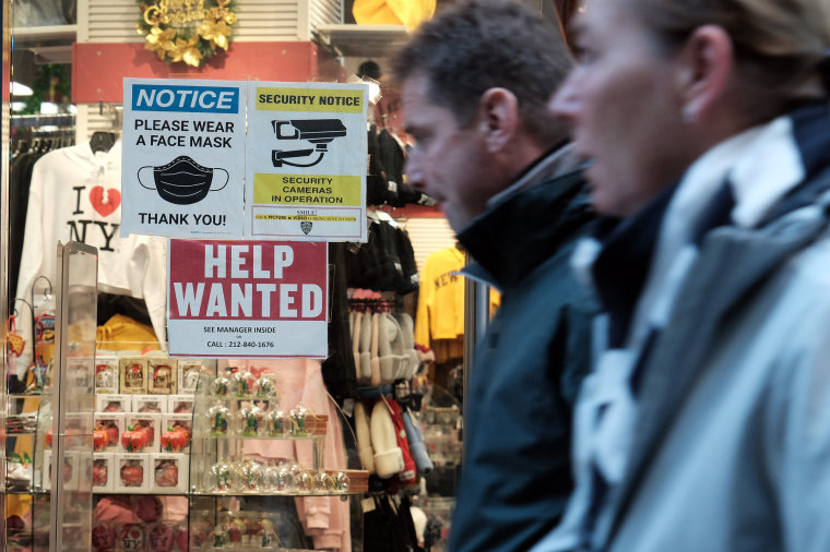  A 'help wanted' sign is displayed in a window of a store in New York City. 