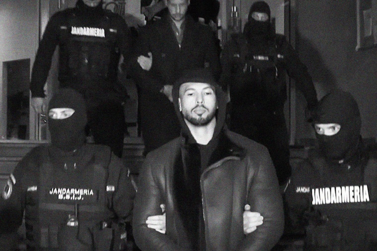 Andrew Tate led away by police in Romania, on Dec. 29, 2022.