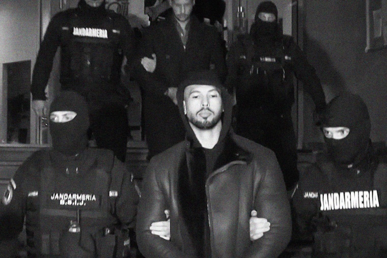 Andrew Tate led away by police in Romania, on Dec. 29, 2022. 