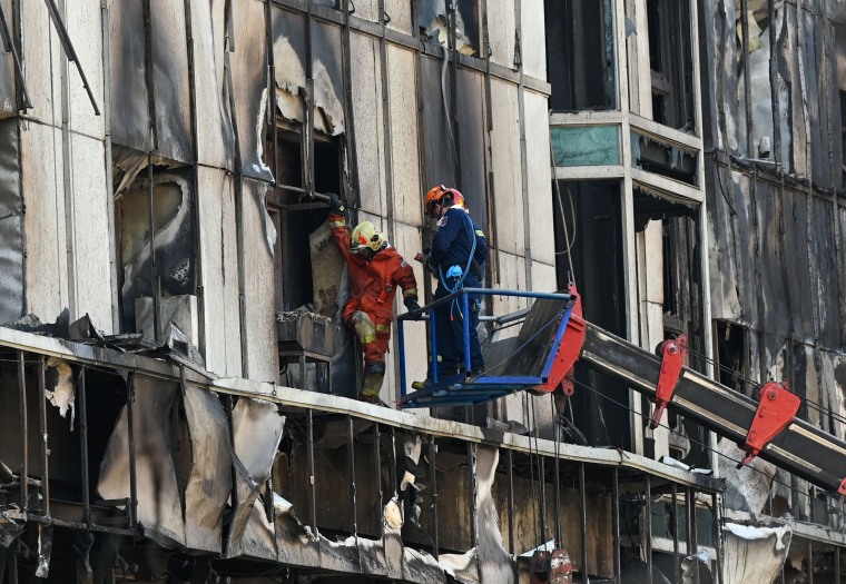 Rescuers scoured the charred ruins of a Cambodian hotel and casino complex on December 30 as the death toll from a fire that forced people to jump from windows rose to 25.