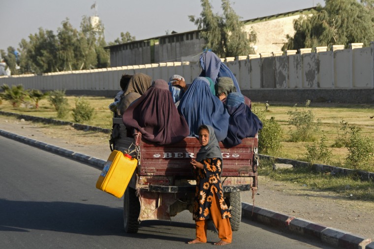 TOPSHOT - Afghan burqa-clad women travel in a vehicle along the road in Kandahar on December 25, 2022. (Photo by Naveed Tanveer / AFP) (Photo by NAVEED TANVEER/AFP via Getty Images)