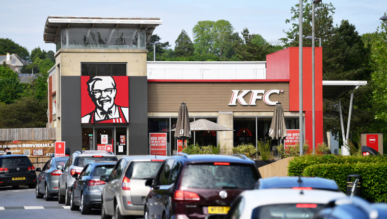 A long queue of cars forms as the KFC drive through.