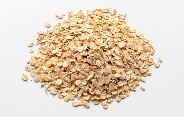 Heaps of rolled oats on a white background