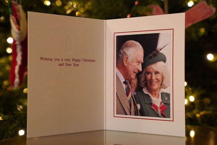The 2022 Christmas card of King Charles III and the Queen Consort in front of a Christmas tree in Clarence House, London.