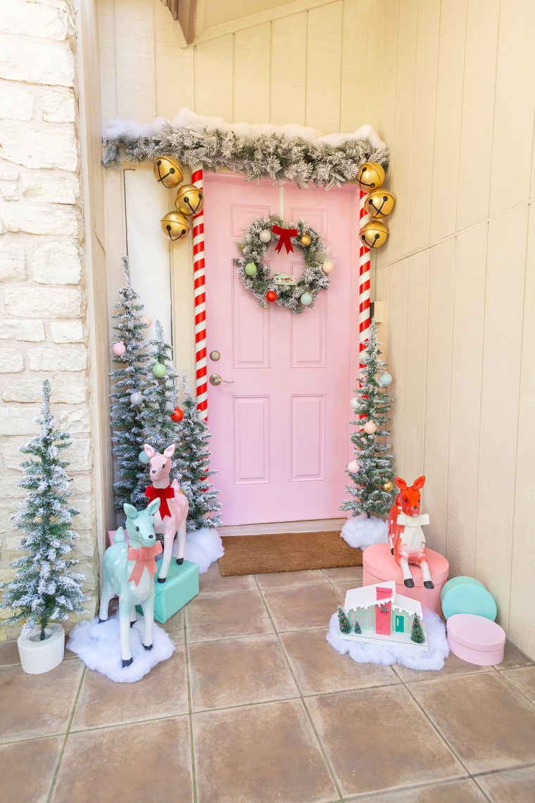 pastel pink front door with wreath, garland and cute deer 