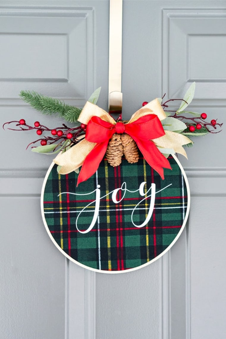 embroidery hoop wreath with plaid fabric and "joy" message