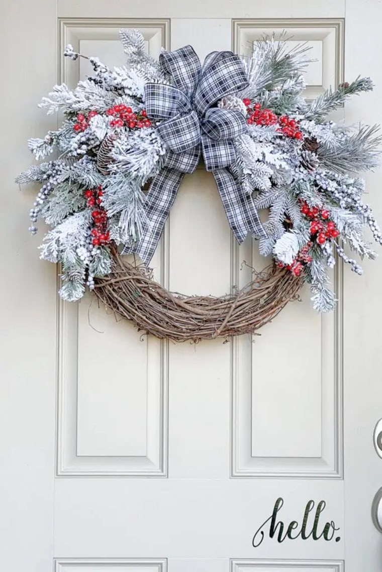 snow and berries on a grapevine wreath