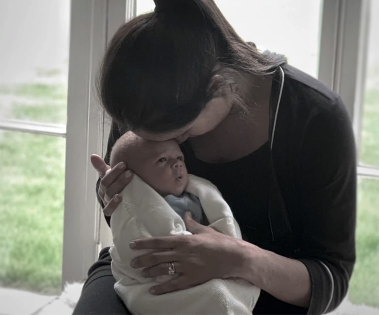 Meghan cradles baby Archie in this intimate photo.