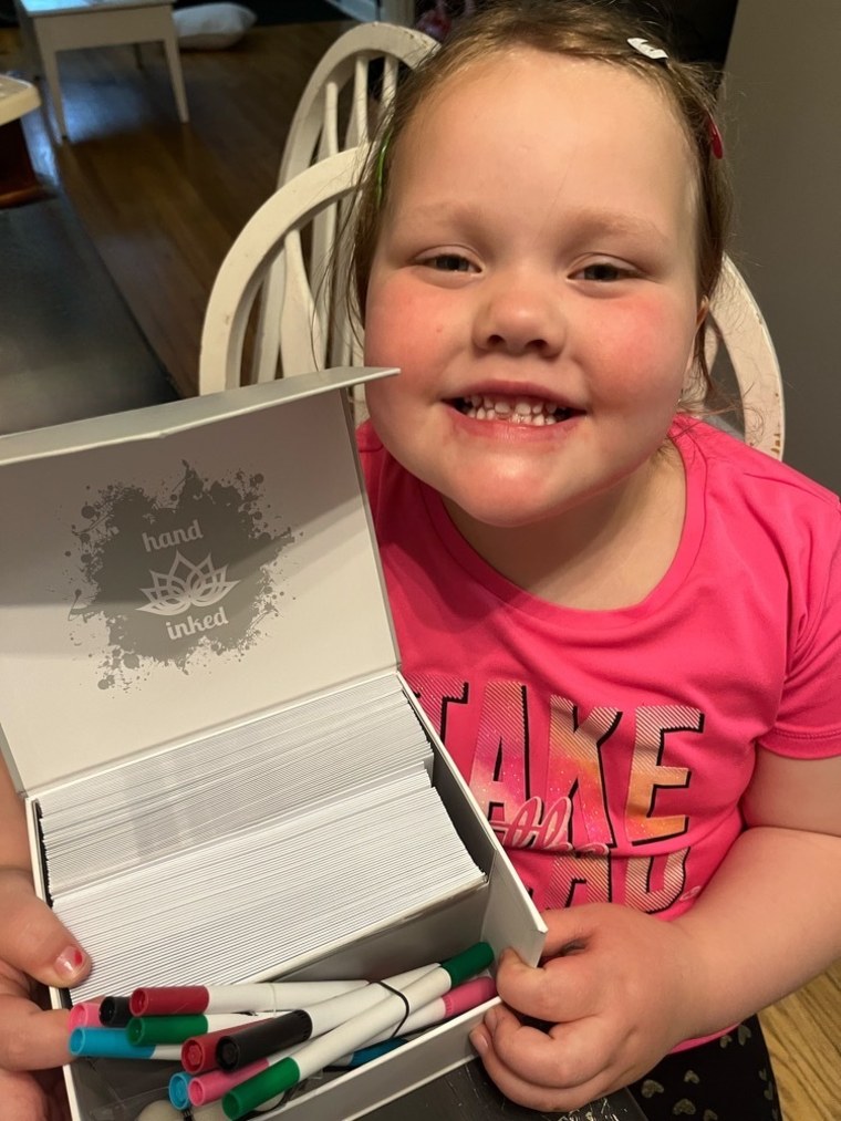 Ruby with stationery and markers she received from "Hand Inked," a greeting card company. 