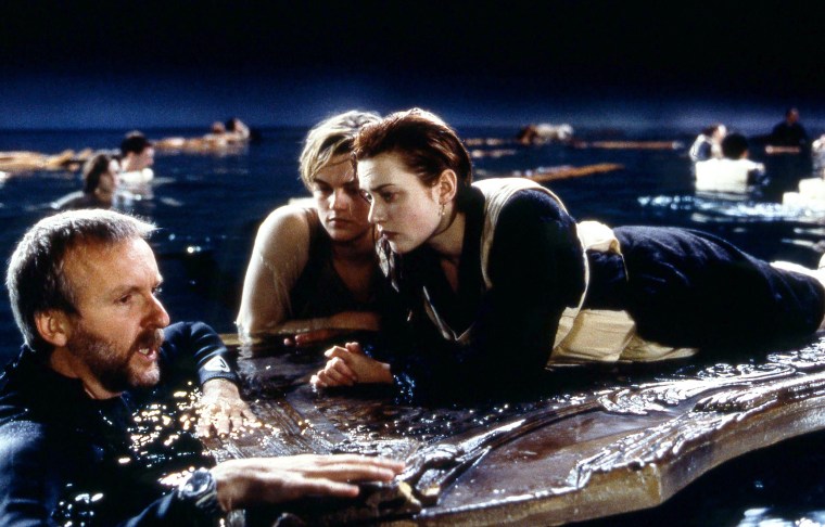 Director James Cameron on set with Kate Winslet as Rose and Leonardo DiCaprio as Jack in "Titanic."