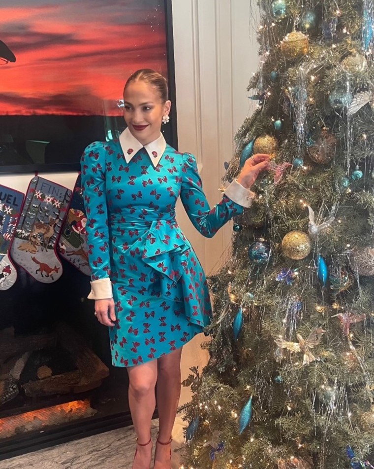 Lopez poses in an adorable dress next to her hummingbird themed Christmas tree. Hummingbirds were a theme for her 2022 holiday party.