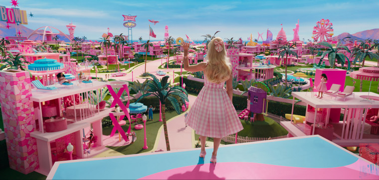 Barbie looks out and waves in the trailer for the 2023 film.