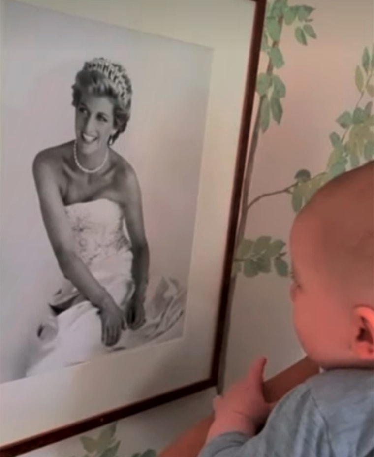 Meghan and Harry's child looking at a photo of Princess Diana.