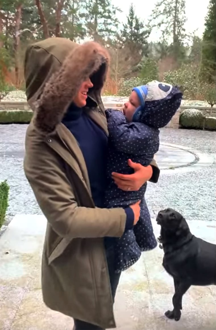 Meghan is seen holding one of her babies in the snow.