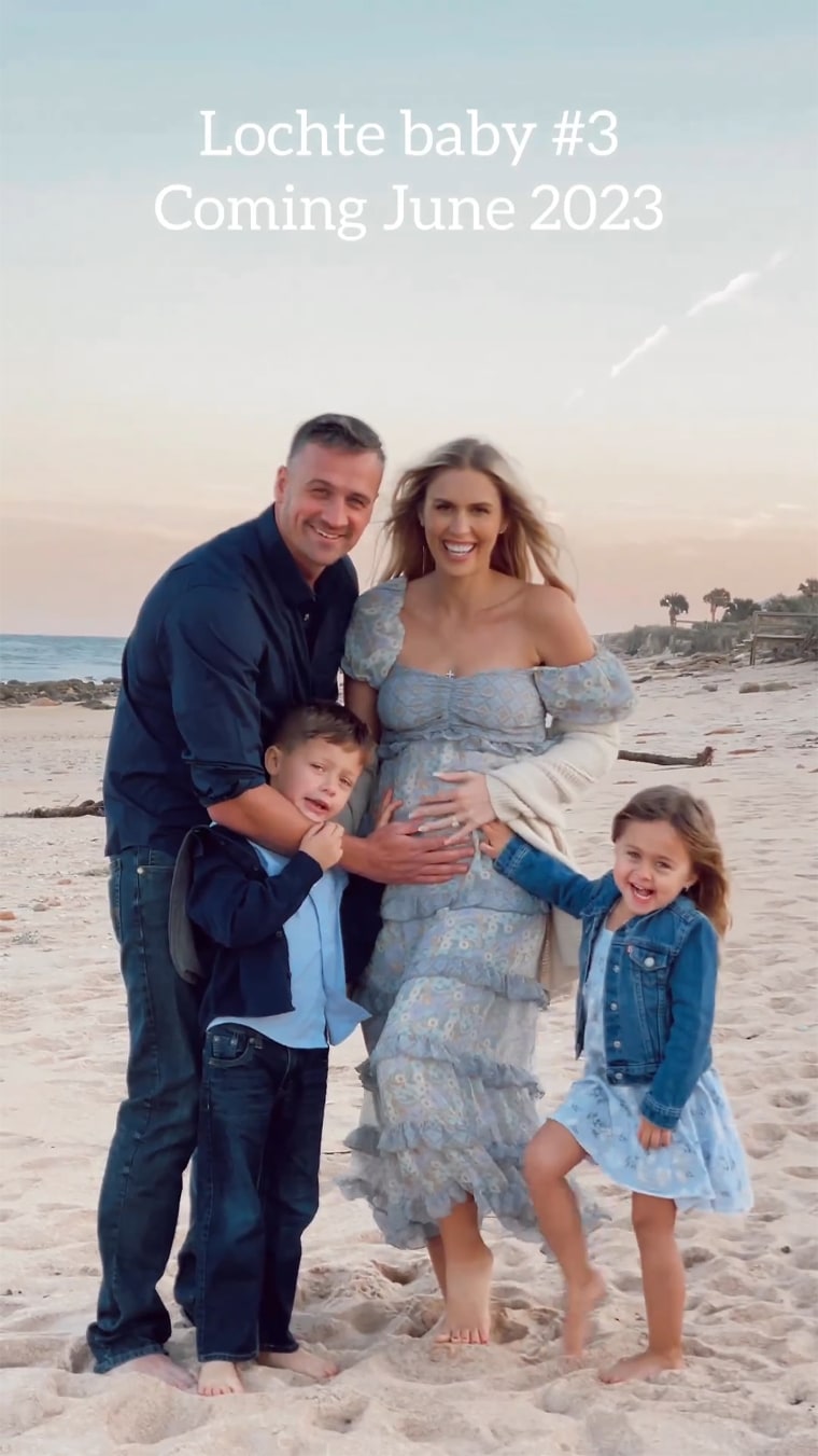 Ryan Lochte, Kayla Rae Reid, and their children, Caiden and Liv, posing on the beach to announce baby No. 3.