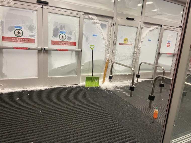 The doors to the Target store covered in snow and ice.