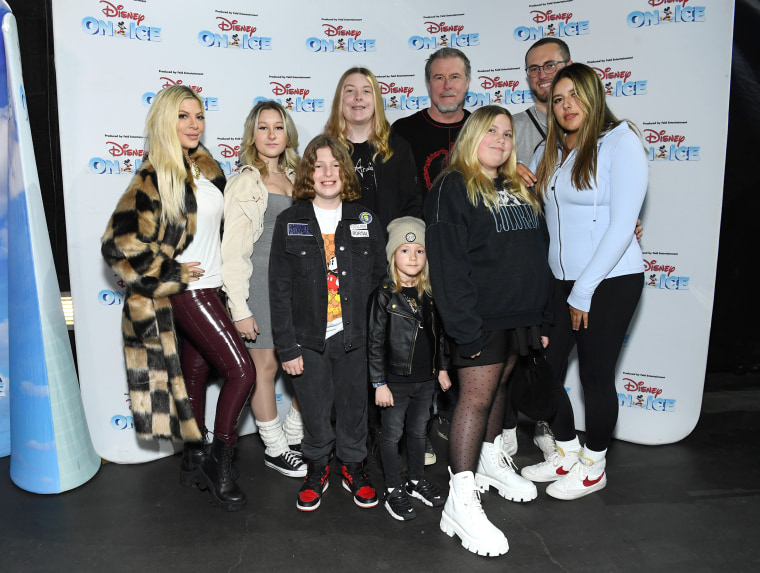 Tori Spelling (L), Dean McDermott (back 2nd R), and kids Liam, Finn, Stella, Beau, Hattie, Jack, and Lola arrive as Disney On Ice presents Road Trip Adventures at Crypto.com Arena on December 09, 2022 in Los Angeles, California. 