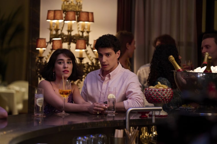 Adam DiMarco as Albie Di Grasso and Simona Tabasco as Lucia Greco having a drink at a bar in "The White Lotus."