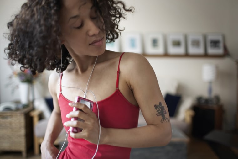 Young Woman with MP3 Player Dancing
