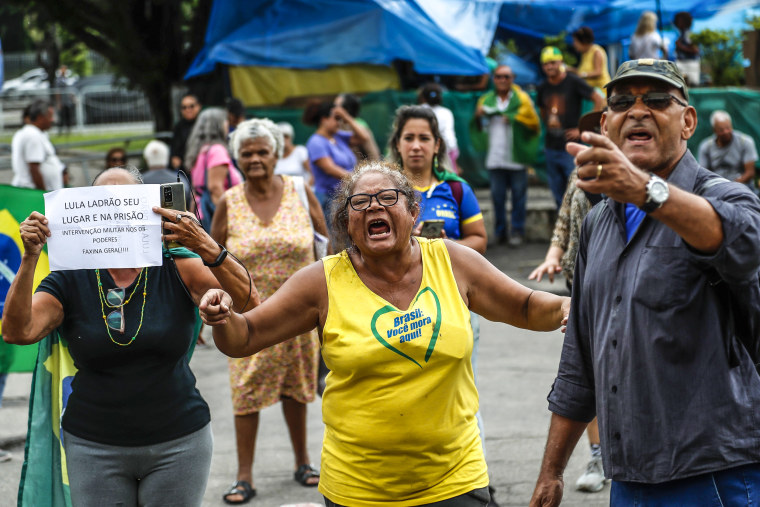 Image: Supporters of former Brazilian President Jair Bolsonaro protest against the press and current President Luiz Inacio Lula da SilvaLula Da Silva as they break camp outside a military base in Rio de Janiero, on Jan. 9, 2023, the day after Bolsonaro supporters stormed government buildings in the capital city of Brasilia.