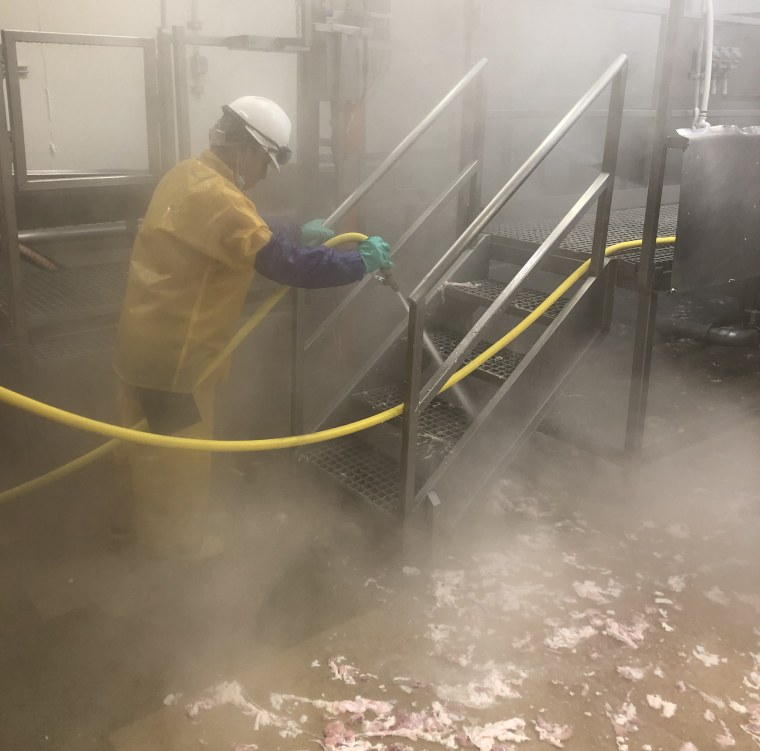 A worker at JBS Foods Plant in Worthington, Minn.