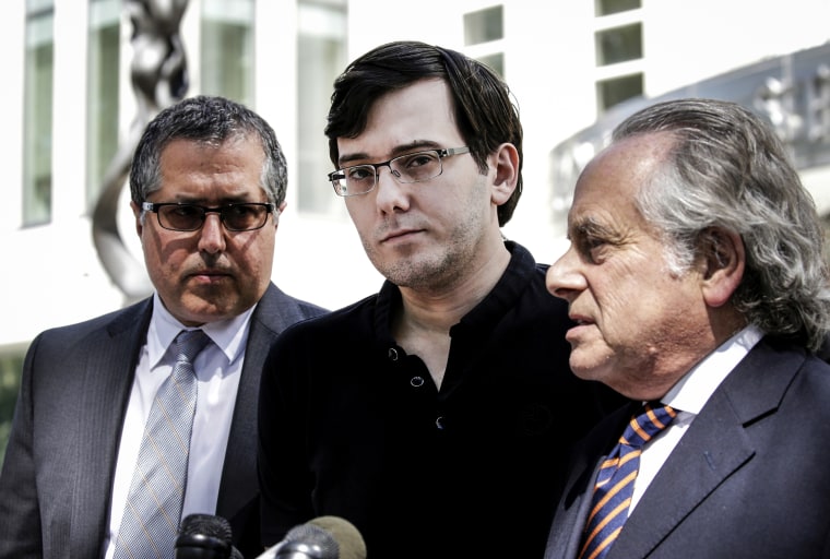 Martin Shkreli listens while his attorney Benjamin Brafman, right, speak to members of the media outside federal court in the Brooklyn, N.Y., on Aug. 4, 2017.