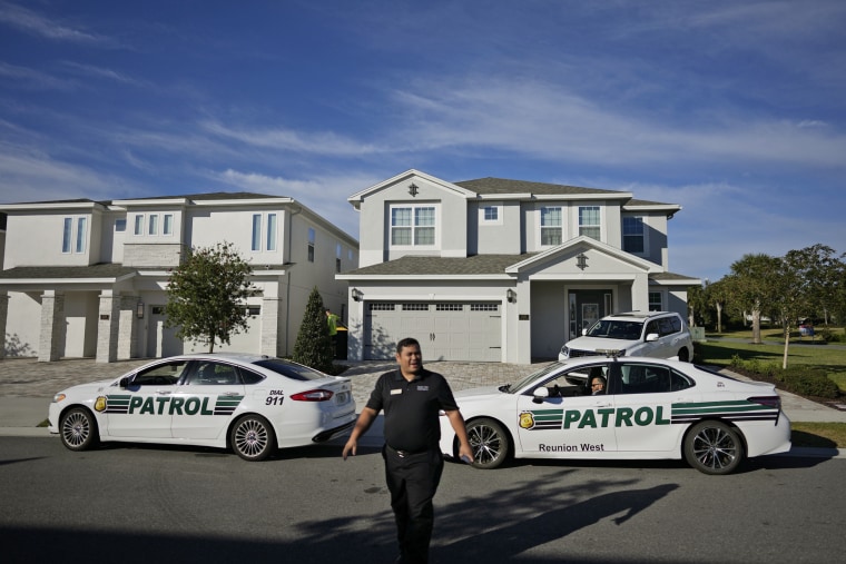 Resort security officers speak to journalists gathered outside the house where former Brazilian President Jair Bolsonaro has stayed on January 10, 2023, in Kissimmee, Florida.