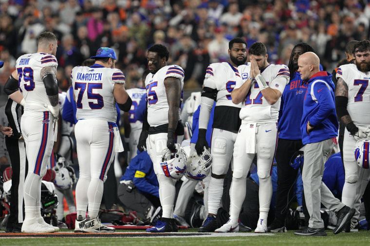 Buffalo Bills quarterback Josh Allen (17) pauses as Damar Hamlin is examined during the first half of an NFL football game against the Cincinnati Bengals on Monday, January 2, 2023, in Cincinnati.