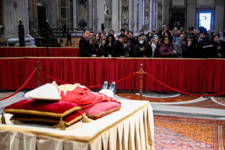 People waiting in line to pay their respects at the body of Pope Emeritus Benedict XVI laying in state at St. Peter's Basilica in the Vatican on Jan. 2, 2023.