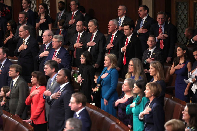 Members of the 118th Congress stand for the Pledge of Allegiance on the first day of the 118th Congress on Jan. 3, 2023. 