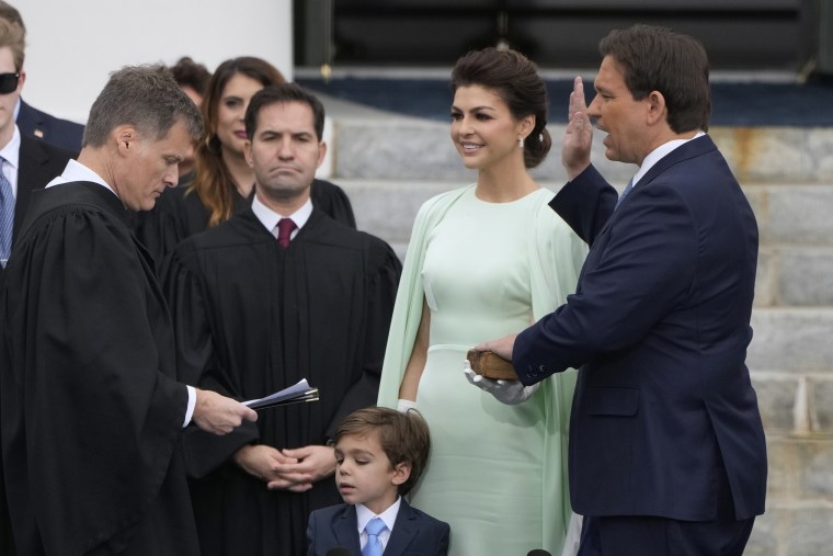 Ron DeSantis, right, is sworn by Florida Supreme Court Chief Justice Carlos Muniz, to begin his second term during an inauguration ceremony outside the Old Capitol, in Tallahassee, Fla