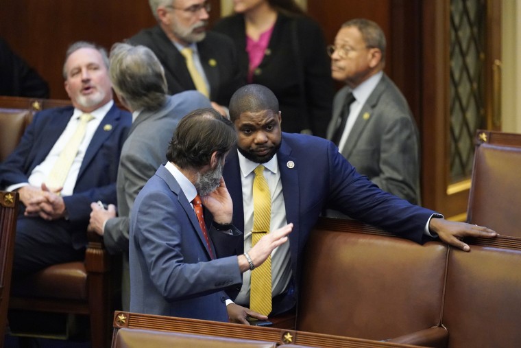 Rep. Byron Donalds, R-Fla., talks with colleagues in the House chamber after six failed votes to elect a new speaker, and a motion to adjourn for the day, in Washington, Wednesday, Jan. 4, 2023.