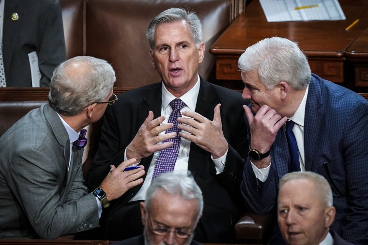 Image: Rep. Patrick McHenry, R-N.C., left, and Rep. Tom Emmer, R-Minn., right, speaks with Rep. Kevin McCarthy, R-Calif., in the House chamber as the House meets for a second day to elect a speaker and convene the 118th Congress in Washington on Jan. 4, 2023.