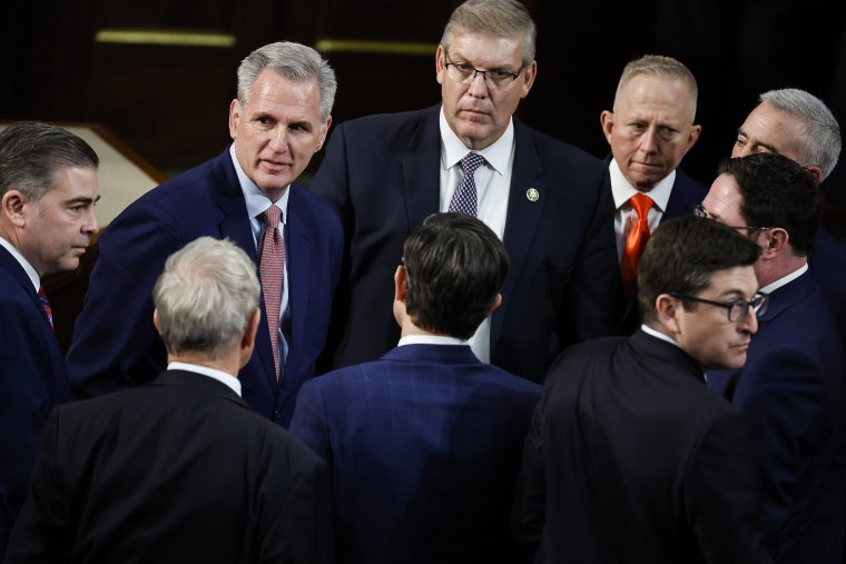Rep. Kevin McCarthy, R-Calif., talks with fellow House Republican in between roll call votes for Speaker of the House of the 118th Congress on Jan. 3, 2023.