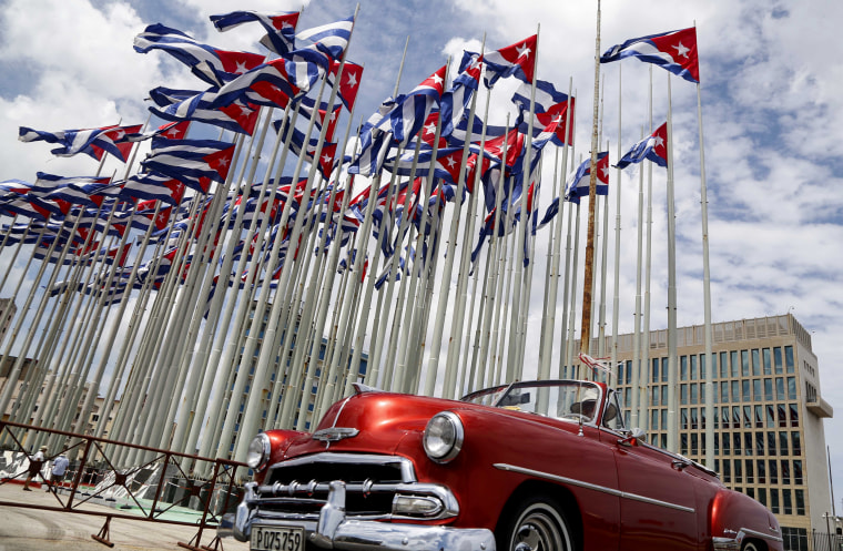 A classic American convertible passes beside the United States embassy in Havana on July 26, 2015.