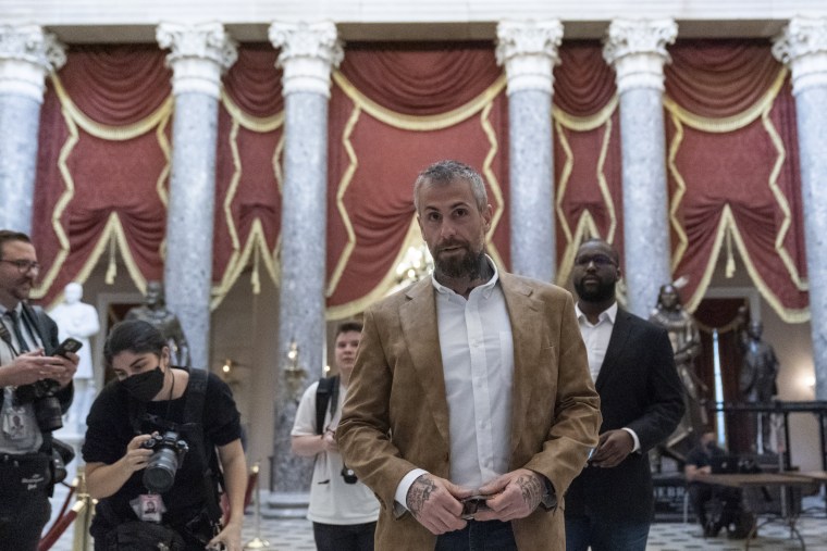 Michael Fanone, center, walks through Statuary Hall at the U.S. Capitol
