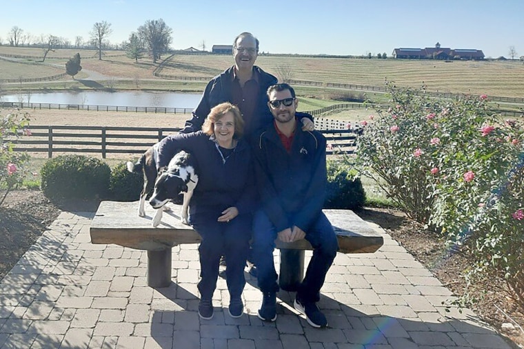 Austin Johnson with his parents, Philip and Kathy Johnson, in November 2022, after his treatment at the University of Michigan.