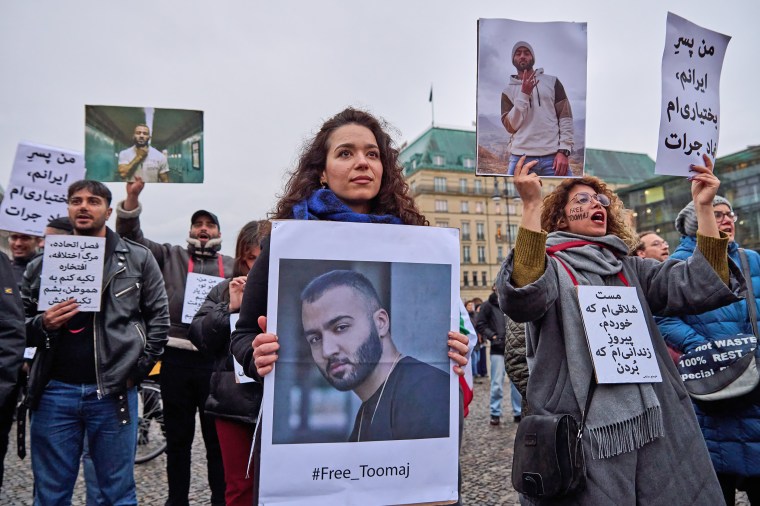 Demonstrators gather at the Brandenburg Gate in Berlin to protest the arrest of Iranian rapper Toomaj Salehi on Nov. 4, 2022.