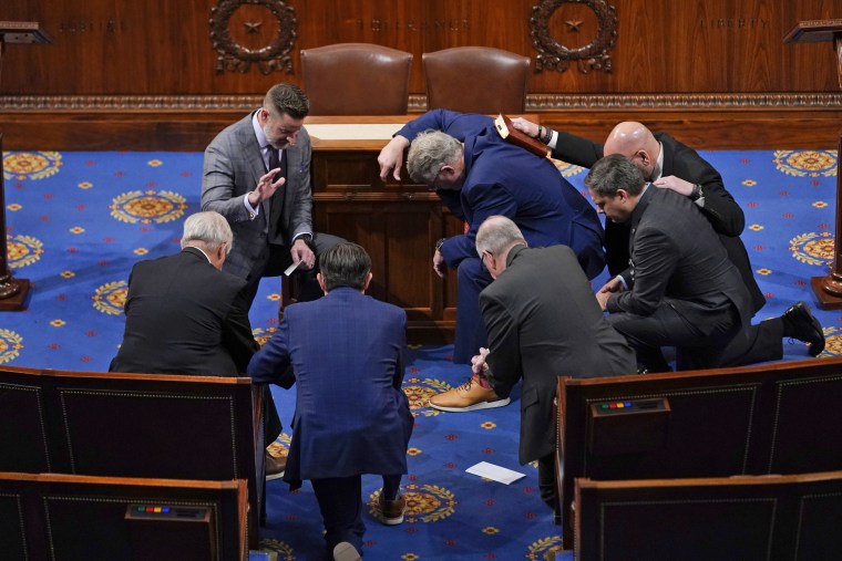 Members of Congress pray in the House chamber before the House meets on Jan. 6, 2023.