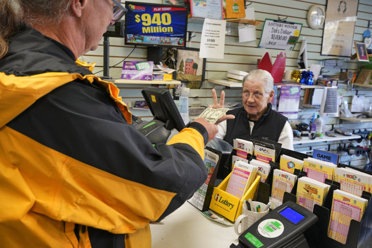 A person purchases a Mega Millions lottery ticket in Mt. Lebanon, Pa.