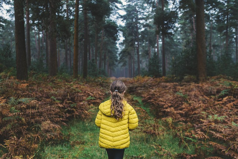 Young girl on forest path
