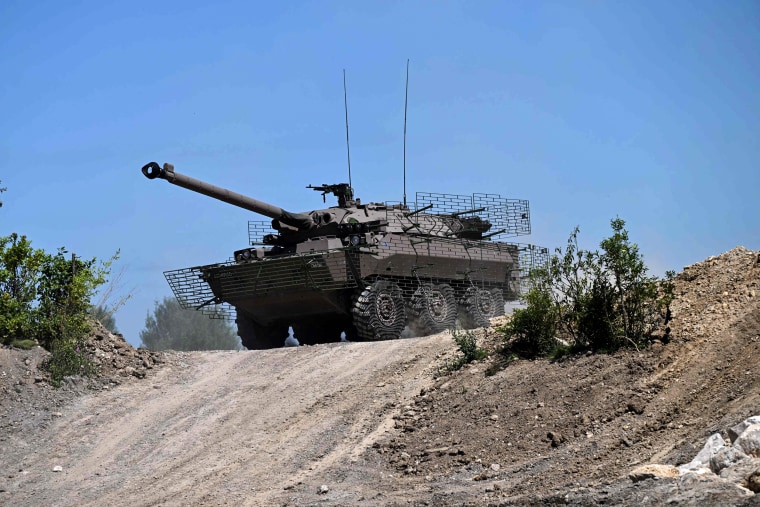 French army soldiers ride an AMX-10 RC armored vehicle as part of a demonstration in the Paris suburb of Villepinte on June 12, 2022.