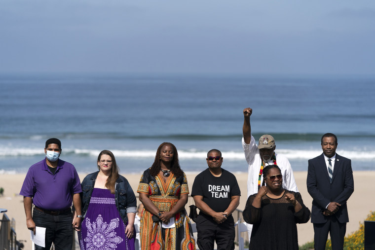 FILE - Anthony Bruce, from left, a great-great grandson of Charles and Willa Bruce; wife, Sandra; Kavon Ward, founder of Justice for Bruce's Beach; Derrick Bruce, great grandson of Charles and Willa Bruce; Chief Duane Yellow Feather Shepard and Mitch Ward attend a dedication ceremony in Manhattan Beach, Calif., Wednesday, July 20, 2022. Southern California beachfront property that was taken from Willa and Charles Bruce, a black couple, through eminent domain a century ago and returned to their heirs in 2022 will be sold back to Los Angeles County for nearly $20 million. The decision to sell what was once known as Bruce's Beach was announced Tuesday, Jan. 3, 2023, by local and state officials who led governmental efforts to undo the long-ago injustice. (AP Photo/Jae C. Hong,File)