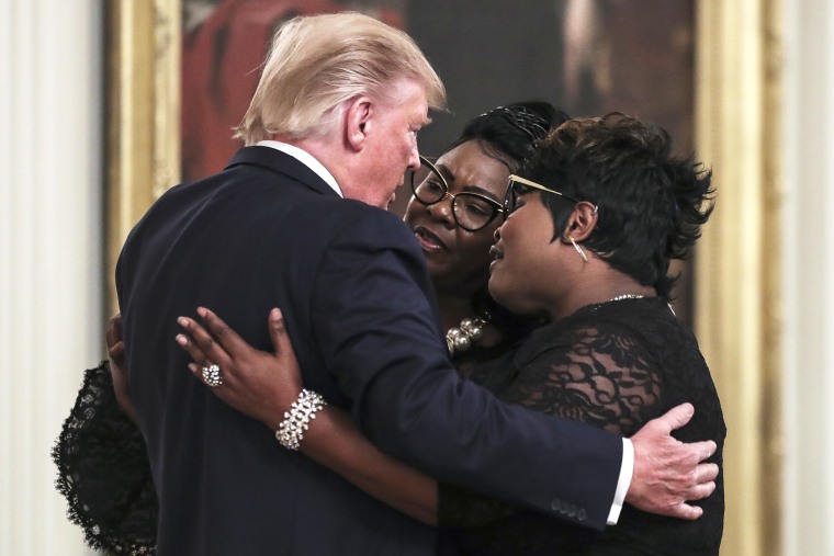 President Donald Trump hugs conservative social media figure Rochelle Richardson, known as Silk of "Diamond and Silk" as she and Lynnette Hardaway, known as Diamond, come on to the stage at the president's invitation at his social media summit with prominent conservative social media figures on July 11, 2019 in Washington, DC. (Photo by Oliver Contreras/SIPA USA)(Sipa via AP Images)