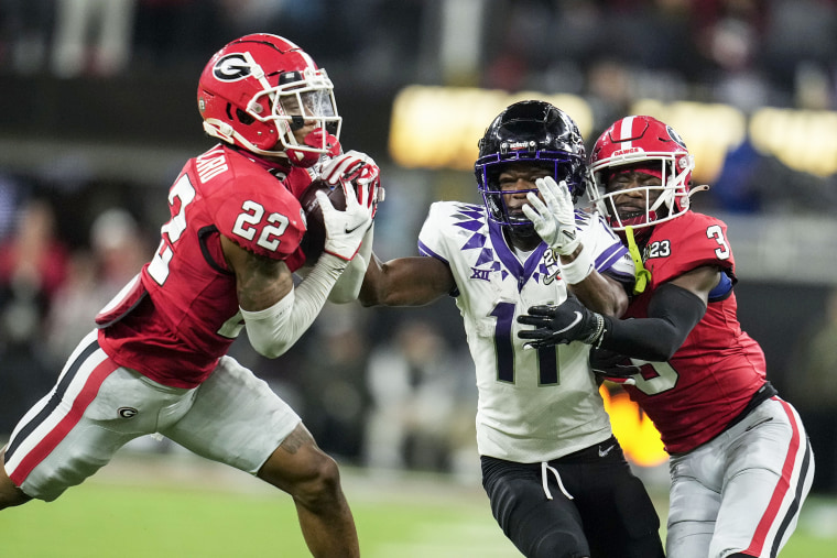 Georgia defensive back Javon Bullard (22) intercepts the ball against TCU wide receiver Derius Davis (11) during the first half of the national championship NCAA College Football Playoff game, Monday, Jan. 9, 2023, in Inglewood, Calif.