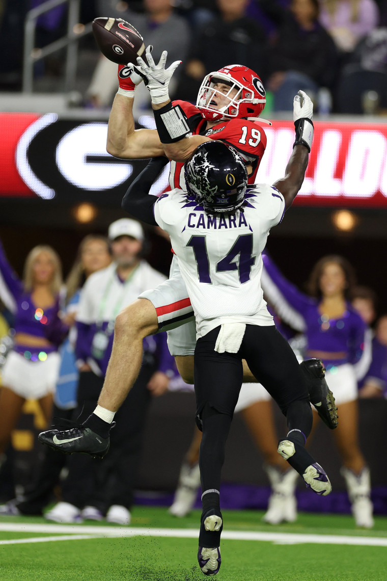 Brock Bowers #19 of the Georgia Bulldogs scores a 22 yard touchdown in the third quarter against Abraham Camara #14 of the TCU Horned Frogs in the College Football Playoff National Championship game at SoFi Stadium on January 09, 2023 in Inglewood, California.