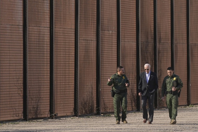 Joe Biden walks with U.S. Border Patrol agents along a stretch of the U.S.-Mexico border in El Paso, Texas